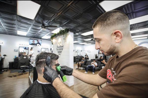 A perfect shot of one of our professionals finishing a haircut with some final touches.