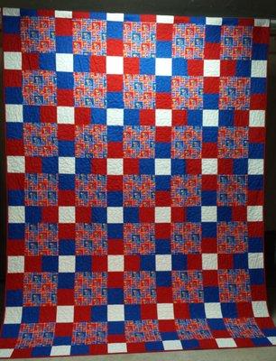 Is KU for you... this quilt may be too! It's 100% cotton and this throw measures 61" X 87."