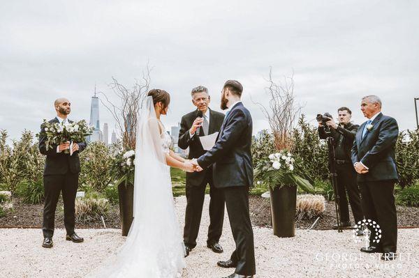 My brother is holding my bouquet and check out those gorgeous giant vases behind us that They created!