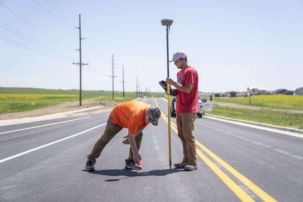 Our Surveyors marking lines on roads.