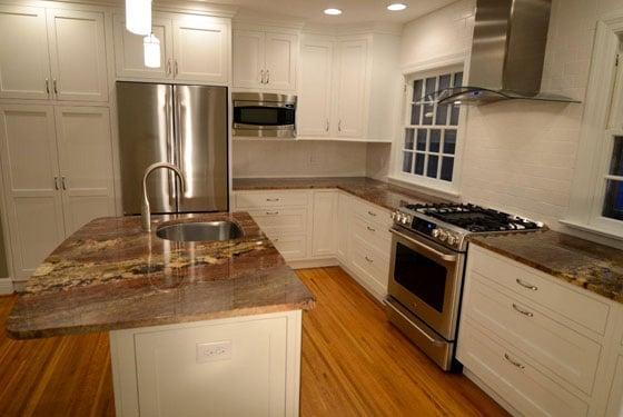 Crisp, white cabinetry in a contemporary style with granite counter tops.