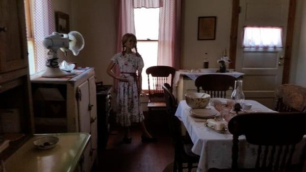 One of 4 rooms in this tiny house. However the real kitchen was outside that back door, in another building.