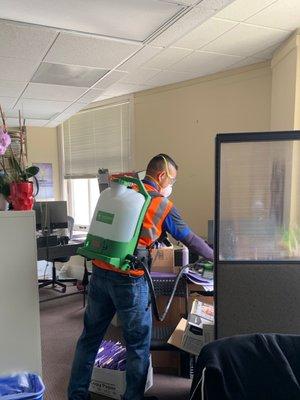 Our team providing backpack electrostatic disinfecting at an office