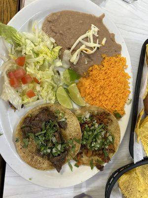 2 taco dinner-al pastor and cecina tacos with Mexican rice and refried beans.