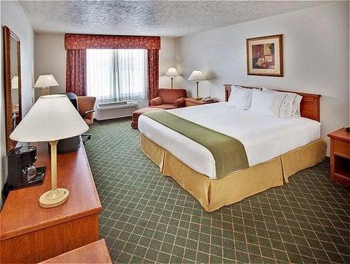 Standard King room features comfortable bed and plush pillows, well-lit work desk, fridge, microwave, HDTV, and high-speed Internet.