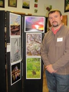 Local Photographer, Michael TIdwell, shows off some of his works on display at the library.