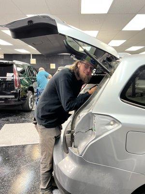 Ron de-trimming the cars before the hail repair procedure