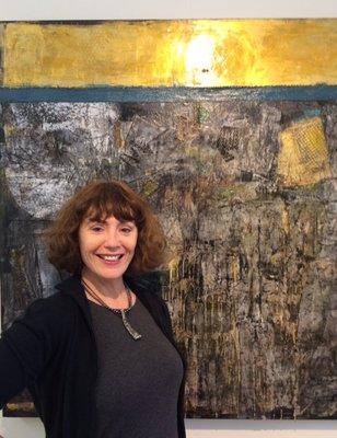 Owner and resident artist Rebecca Joskey. Featured painting, "Gold Rising to the Top"