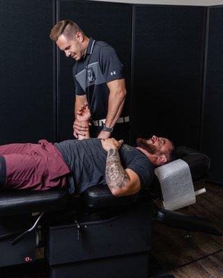 Dr. Chris Jepsen performing myofascial release on a patients shoulder and elbow