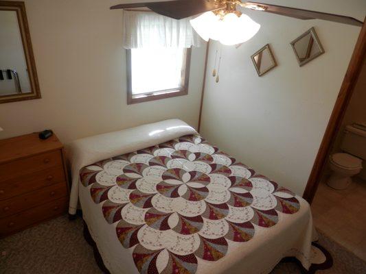 This master bedroom has a spacious bathroom with tub and shower off of it.