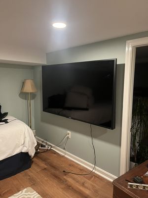 90-inch tv installed on an articulating wall mount.