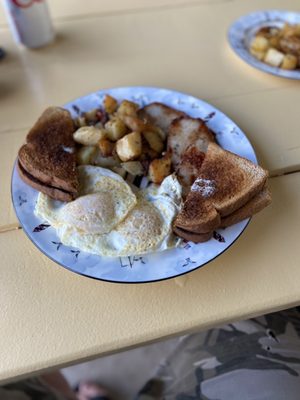 Fried tenderloin, perfectly cooked eggs over medium, delicious home fries and wheat toast.