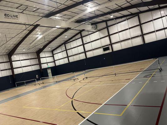 Indoor gym set up with 3 pickleball courts within the GoLive Event Center