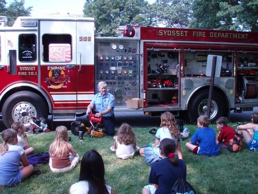 Kids learning about the equipment on a fire engine from SFD Fire Prevention Officer