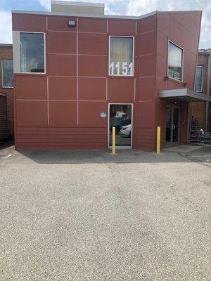 The outside of the building and the parking lot where you can park at the door.