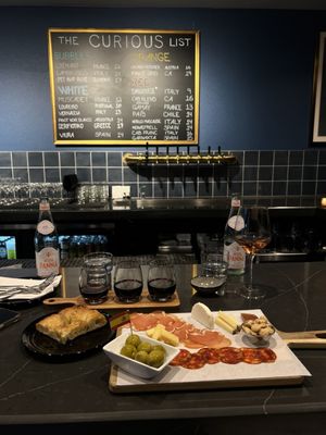 Spanish charcuterie board, focaccia bread, wine flight