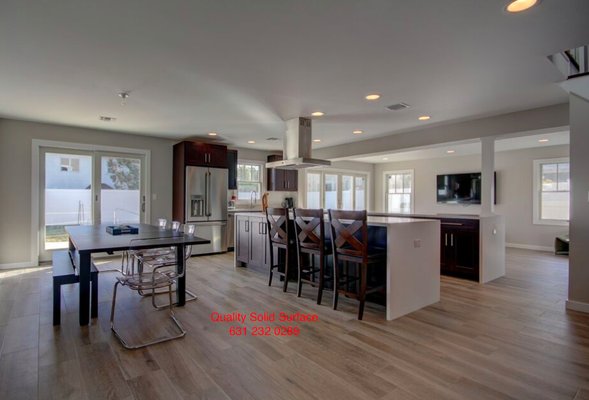 Kitchen with waterfall integral panels made out of arctic white