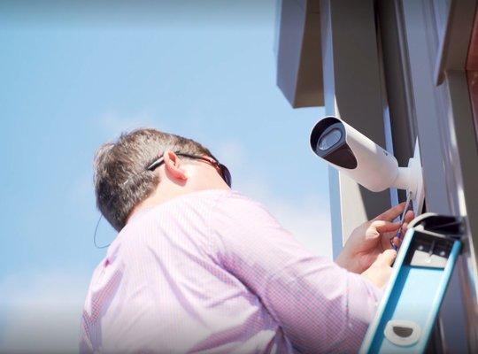 Pollock Company employee installing physical security devices for local company