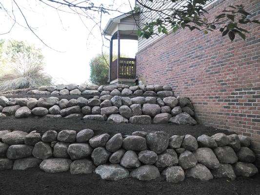 A three tiered retaining wall to help eliminate wash out issues along this customers foundation.