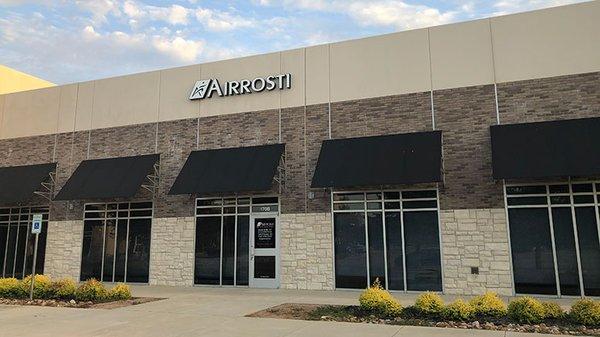 An exterior view of the Airrosti Keller building. The Airrosti sign is prominently displayed above the front entrance.