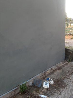 Me painting a garage wall for a customer