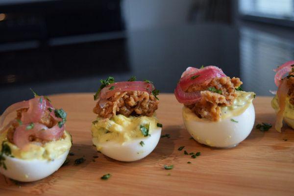 Lobster bites deviled eggs. Topped with pickled onions.