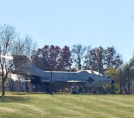 A McDonnell Douglas F-101 fighter jet sits atop a hill in the center of the park.