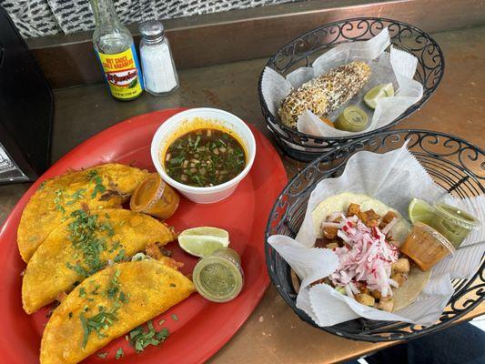 Birria taco set, homemade corn tortilla al pastor, and elote