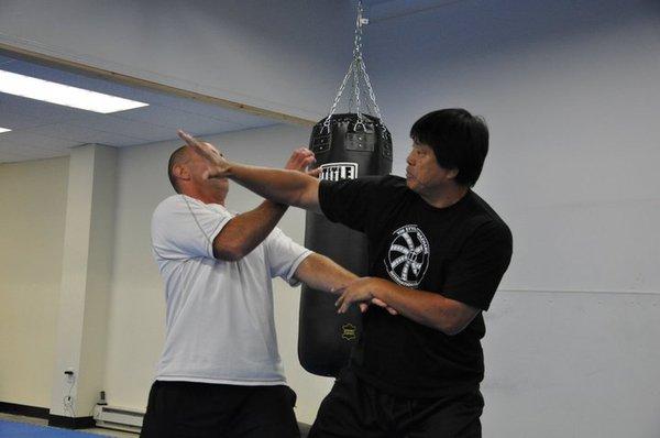 Jinbao demonstrating a lion sweeping technique on mike