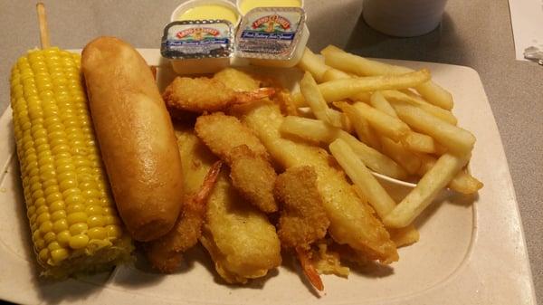 Fish and shrimp with a side of corn.