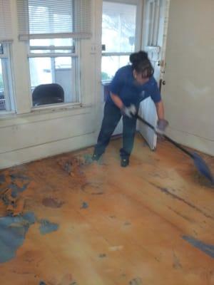 Peeling up decades old carpet to restore the wood floor underneath