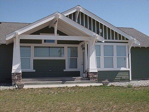 Craftsman with heavy beams, tapered posts and stone