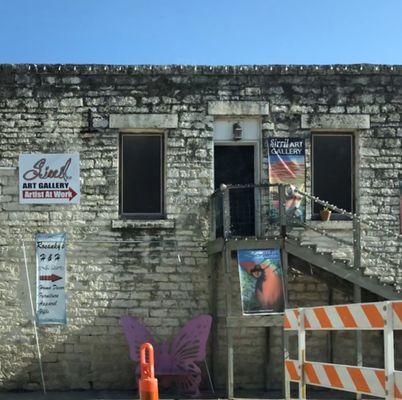 Gallery is upstairs above "Sugar Shack" candy store.