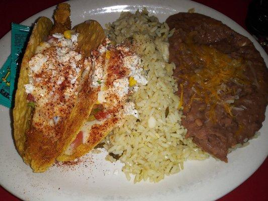 2 queso shrimp tacos, crispy, cilantro lime rice and refried beans. Add one Coors and it made a great dinner.