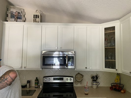 Painted cabinets and installed hardware.