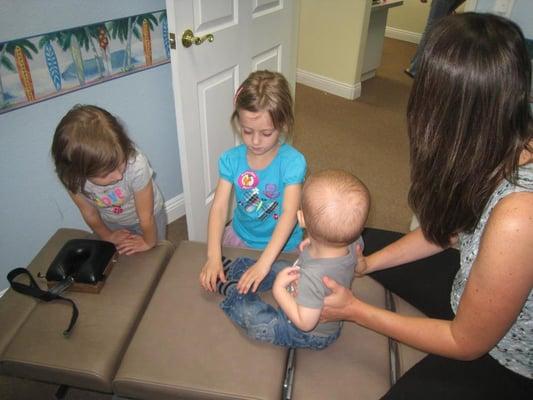 Dr. Campagna adjusting Carter at 13 months with a few helpers.