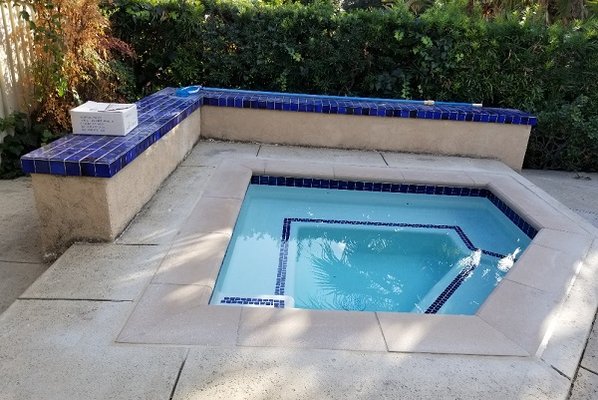 Spa, with angled geometric lines.  Spa bench has original tile.  We were able to match it closely.  (Box of leftover tile is on the bench.)