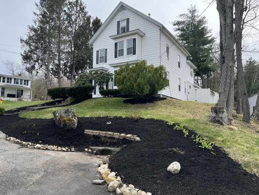 Very clean edging
 Bushes shaped nicely
 Black mulch just gives you that pop curve appeal