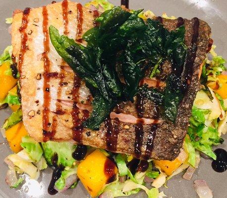 Salmon over Brussels and squash with crispy spinach