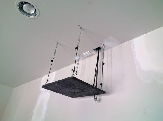 The DIY projector mount that they mounted to the ceiling.  An additional support beam was added in the ceiling for further security.