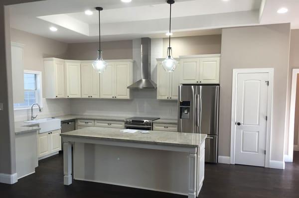 Quartz countertop beautiful finish along with beautiful white cabinetry.