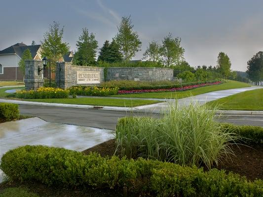 Pembrooke Village stone entrance leading into high-end residential subdivision with luxurious landscape design