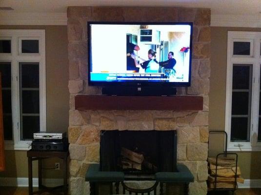 55 inch mounted on stome fireplace. Electrical outlet behind TV and concealed wiring through the stone.