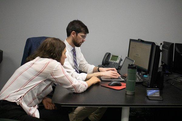 SEO Specialist, Eric Wallace, and Google Ads Specialist, Megan Patton, work together on a project.