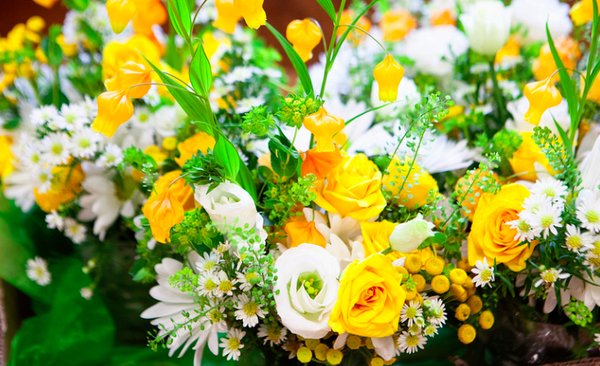 Secret Garden arrangement creatively using whites, oranges, yellows and greens.