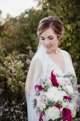 Locally grown bridal bouquet including blue eryngium and fuchsia celosia by Beautiful Blooms by Jen. Photo by Twig and Olive Photography.