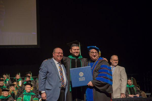 Dr. Zachery Weinberg receiving his diploma from the Southern College of Optometry.