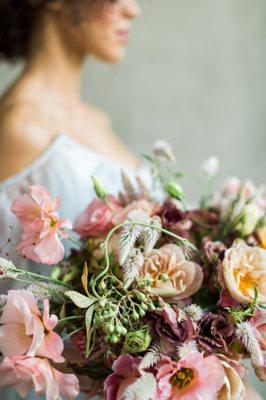 bouquet of pink roses, blurry bride in the background