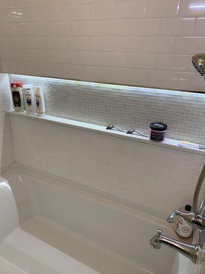 Subway tile, glass, quartz, and a full width lighted niche!