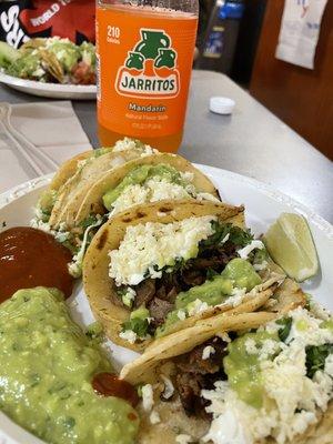 Bistec and chicken tacos with cream and queso fresco, guacamole and salsa roja on the side. Mouth watering delicious.